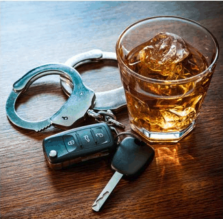 Handcuffs next to car keys and alcoholic drink